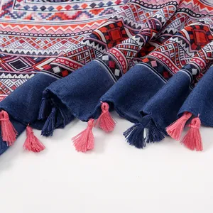 Detail of bohemian scarf showing geometric patterns and colorful handmade tassels
