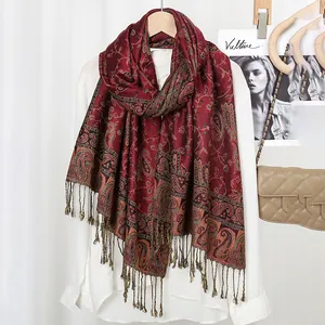 Detailed view of paisley embroidery and tassel trim on burgundy ethnic style shawl scarf