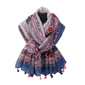 Bohemian geometric pattern scarf with blue and pink tassels on white background