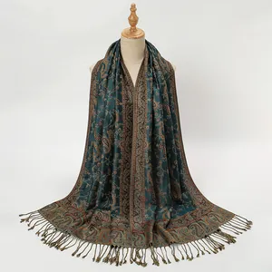Detailed view of the dark teal paisley scarf featuring elegant vintage print and fringe edges
