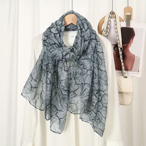 Elegant grey scarf with black marble print on thin fabric, styled for spring outfits