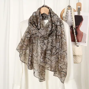 Detail of soft breathable spring scarf with vintage branch pattern on light fabric