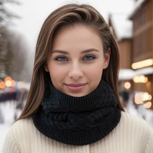 Classic black cable-knit infinity scarf for winter warmth against a snowy background