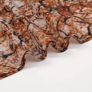 Lightweight voile scarf with branch pattern print in brown and orange for spring