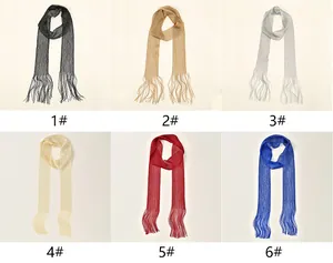 Detail of glittery mesh scarves with fringe tassels in six different metallic colors