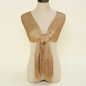 Detailed view of a golden metallic shawl with long fringe and front knot design
