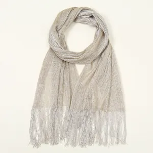 Detail of champagne gold and silver metallic shawl with elegant fringe tassels