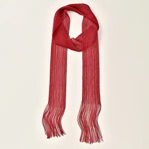 Close-up of red mesh scarf with shiny metallic threads and long fringe details