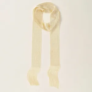 Close-up of champagne gold scarf featuring subtle shimmer fabric and delicate fringe detail