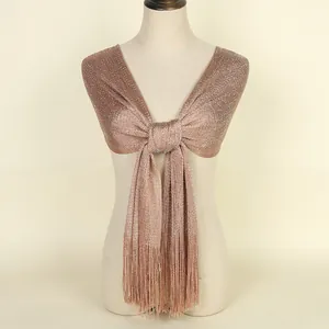 Close-up of champagne gold lurex scarf showing intricate tassel fringe details and shimmer