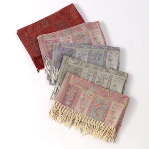 Detail of five paisley jacquard pashmina shawls with fringed edges in various colors