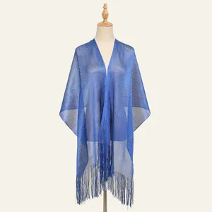 Detail of royal blue mesh shawl with shimmering metallic thread and long fringe trim