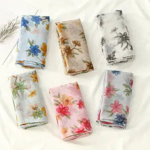 Collection of lightweight floral print scarves for women in various pastel colors