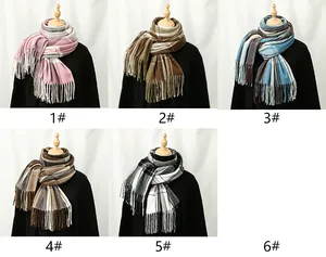 Detail shot of various plaid patterns and fringed edges on cashmere-like winter scarves