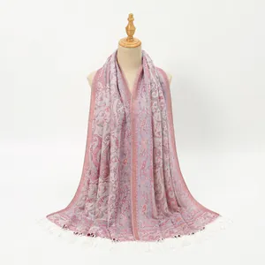Detail of paisley floral scarf with white tassels on a mannequin for styling