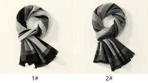 Detail view of two plaid cashmere-like scarves with fringe and striped patterns
