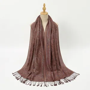 Close-up of paisley pattern and woven tassels on a vintage brown polyester shawl