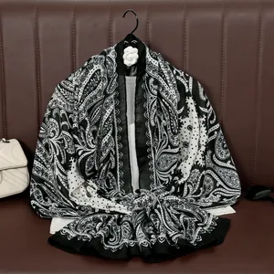 Lightweight paisley print beach shawl in black and white with lace border