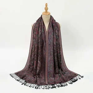 Detail of bohemian paisley shawl with long tassels on a mannequin in high quality