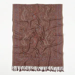 Detail of paisley pattern and twisted tassels on a long dark brown polyester shawl