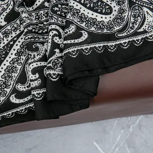 Detail of high-contrast paisley print on soft breathable beach shawl fabric