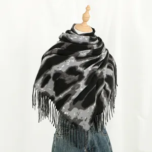 Detail of grey tie-dye thick cashmere-like scarf featuring decorative long tassels