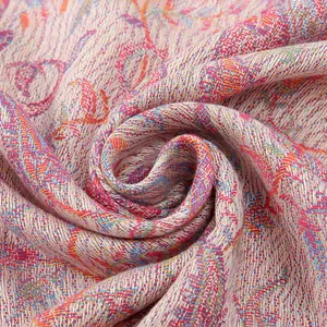Detailed macro view of the paisley pattern and silky texture on this woven shawl scarf
