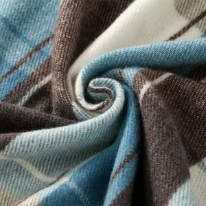 Detailed macro view of soft plaid cashmere-like fabric showing blue and brown weave texture
