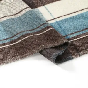 Detailed macro view of soft plaid cashmere-like fabric with twill texture and raw edges