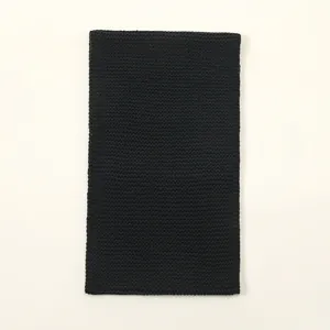 Detail of black thick knitted snood scarf featuring premium chunky woven texture