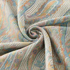 Macro shot of paisley pattern jacquard scarf showing intricate fabric texture and fringe