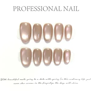 Glossy champagne gold cat-eye press-on nails in short round shape with pearl luster