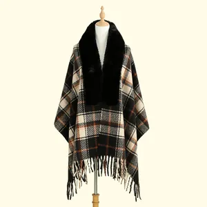 Detail of vintage plaid shawl with faux fur collar and fringe hem on a mannequin