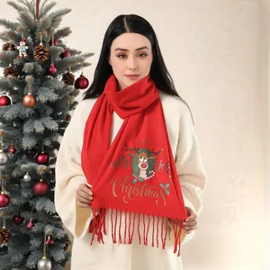 Detail of red Christmas scarf with reindeer print and festive fringe tassels on a model