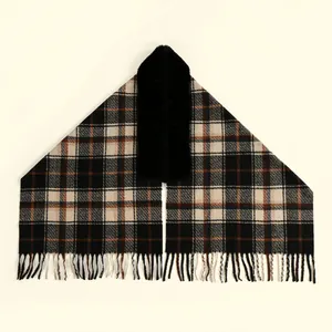 Detail of plaid cashmere-like shawl with black faux fur collar and tassel hem decoration