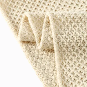 Unisex cream chunky knit snood with textured honeycomb waffle pattern for winter warmth