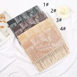 Detail view of four cashmere-style scarves with palm leaf jacquard and tassel edges