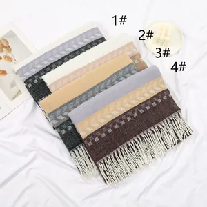 Detail of four cashmere-style scarves with fringe and classic wave patterns