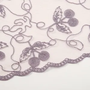 Close-up of purple lace shawl with cherry embroidery and scalloped crochet edges