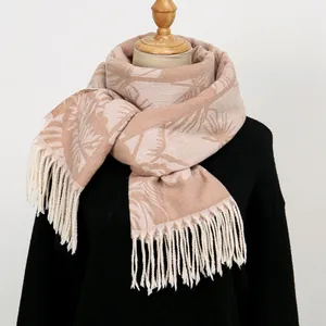 Detail of soft jacquard scarf with leaf pattern and elegant fringe trim texture