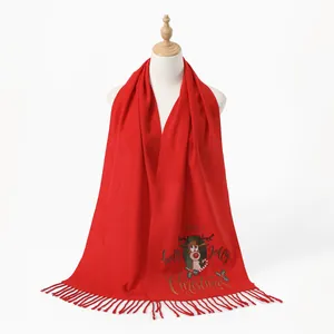 Detail of red Christmas scarf with reindeer pattern and festive holiday embroidery