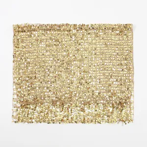 Macro shot of gold sequin fabric details showing the metallic grid texture and glitz finish