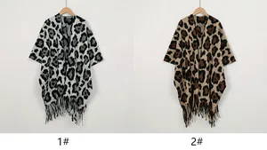 Comparison of grey and brown leopard print knitted capes on wooden hangers