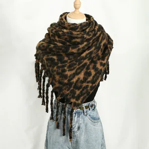 Detailed view of the thick leopard print cashmere-like scarf with fringe accents