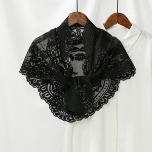 Detailed view of black floral lace triangle scarf with intricate scalloped hollow edges