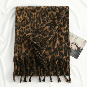 Macro shot of thick leopard print scarf showing soft texture and tassel detail
