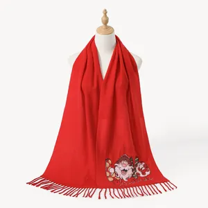 Red Christmas scarf with Santa Claus pattern and fringe trim on a white mannequin