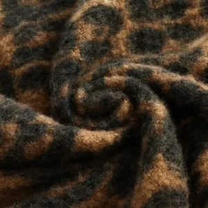 Close-up of thick leopard print scarf showing soft cashmere-like fuzzy texture and knitting