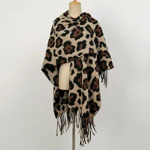 Detailed view of thick knit leopard print shawl featuring elegant long tassels and wild style