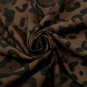 Close-up of leopard print fabric texture showing soft stretch cotton weave and drape
